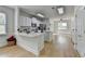 Open-concept kitchen with white cabinetry, stainless appliances and a view to the dining area at 3120 Caney Creek Ln, Cumming, GA 30041