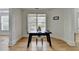 Living room with wood floors, large windows, and a black desk at 3120 Caney Creek Ln, Cumming, GA 30041