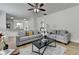 Spacious living room featuring wood flooring, ceiling fan and modern furnishings at 3120 Caney Creek Ln, Cumming, GA 30041