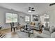 Bright open living room features hardwood floors, ceiling fan, and natural light at 3120 Caney Creek Ln, Cumming, GA 30041