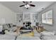Bright living room with white built-in shelves, fireplace, ceiling fan and hardwood floors at 3120 Caney Creek Ln, Cumming, GA 30041