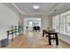 Bright living room featuring wood floors, tray ceilings, and large windows with natural light at 3120 Caney Creek Ln, Cumming, GA 30041