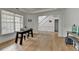Bright, open living room featuring wood floors, large windows, and access to the staircase at 3120 Caney Creek Ln, Cumming, GA 30041