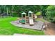 A community playground with slides, climbing structures, and a bench on the side at 3120 Caney Creek Ln, Cumming, GA 30041
