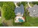 Aerial view of a home with a large in-ground pool and outdoor entertaining area at 5860 Stoneleigh Dr, Suwanee, GA 30024