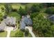 An aerial view of a luxurious home with a backyard pool and beautifully landscaped grounds at 5860 Stoneleigh Dr, Suwanee, GA 30024