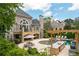 Expansive backyard with a pool, outdoor kitchen, patio, and lush landscaping, perfect for entertaining at 5860 Stoneleigh Dr, Suwanee, GA 30024