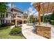 Luxury home backyard featuring a beautiful pool, patio, outdoor kitchen, and lush landscaping at 5860 Stoneleigh Dr, Suwanee, GA 30024