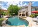 Beautiful backyard pool and patio with a pergola, outdoor kitchen, and spiral staircase at 5860 Stoneleigh Dr, Suwanee, GA 30024