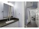 Bathroom featuring a vanity with stone countertops, chrome fixtures, and a walk-in shower with glass doors at 5860 Stoneleigh Dr, Suwanee, GA 30024