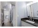 Bathroom featuring a vanity with stone countertops, chrome fixtures, and a walk-in shower with glass doors at 5860 Stoneleigh Dr, Suwanee, GA 30024