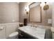 Elegant powder room features a marble countertop, designer fixtures, and stylish wallpaper at 5860 Stoneleigh Dr, Suwanee, GA 30024