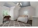 Bright bedroom featuring a statement light fixture, hardwood floors, and a sitting area with lots of light at 5860 Stoneleigh Dr, Suwanee, GA 30024