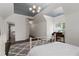Bright bedroom featuring a statement light fixture, hardwood floors, and an en-suite bathroom at 5860 Stoneleigh Dr, Suwanee, GA 30024