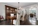 Elegant dining room with dark wood floors, a stylish light fixture, and a charming hutch at 5860 Stoneleigh Dr, Suwanee, GA 30024