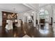 Elegant dining room featuring dark wood floors, a modern light fixture, and classic furnishings at 5860 Stoneleigh Dr, Suwanee, GA 30024