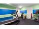 The exercise room boasts plenty of equipment with colorful decoration at 5860 Stoneleigh Dr, Suwanee, GA 30024