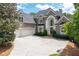 Stunning two-story traditional home with a three-car garage and a grand arched entryway at 5860 Stoneleigh Dr, Suwanee, GA 30024