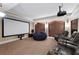 A cozy home theater features a large screen, comfortable seating, and built in speakers at 5860 Stoneleigh Dr, Suwanee, GA 30024