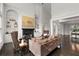 Bright living room boasts fireplace, high ceilings, and an open floor plan to dining area at 5860 Stoneleigh Dr, Suwanee, GA 30024