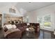 Cozy living room with a cathedral ceiling shows natural light and open access to the gourmet kitchen at 5860 Stoneleigh Dr, Suwanee, GA 30024