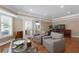 This light-filled sitting area has hardwood floors and leads to a nearby office at 5860 Stoneleigh Dr, Suwanee, GA 30024