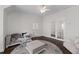 Cozy sitting room with natural light, decorative rug, and hardwood flooring at 5860 Stoneleigh Dr, Suwanee, GA 30024