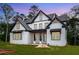 Beautiful white brick home features black trim and a covered front porch at 1072 Sweet Mia Ln, Powder Springs, GA 30127