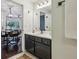 Modern bathroom vanity with a white countertop and dark cabinetry leading into the dining room at 2700 Pine Tree Ne Rd # 1208, Atlanta, GA 30324