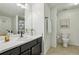 This bathroom has black cabinets and a well-lit mirror at 2700 Pine Tree Ne Rd # 1208, Atlanta, GA 30324