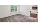 This bedroom has plush carpet and a window that overlooks the balcony at 2700 Pine Tree Ne Rd # 1208, Atlanta, GA 30324