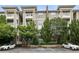 Exterior view of condo units featuring multiple balconies, brick accents, and lush landscaping at 2700 Pine Tree Ne Rd # 1208, Atlanta, GA 30324