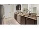 This kitchen has a granite countertop, stainless steel appliances, and dark wood cabinets at 2700 Pine Tree Ne Rd # 1208, Atlanta, GA 30324
