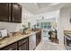 Open kitchen with granite countertops, stainless steel appliances, and a view of the living room at 2700 Pine Tree Ne Rd # 1208, Atlanta, GA 30324