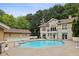 Exterior of the building and community pool and tanning area surrounded by beautiful landscaping and a grilling area at 2700 Pine Tree Ne Rd # 1208, Atlanta, GA 30324