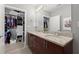 Double sink bathroom vanity with large mirror, overhead lighting and a walk in closet at 400 W Peachtree Nw St # 3611, Atlanta, GA 30308