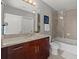 Modern bathroom featuring granite countertops, sleek cabinetry, and a glass-enclosed shower-tub combination at 400 W Peachtree Nw St # 3611, Atlanta, GA 30308