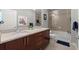 Stylish bathroom featuring a granite countertop, double undermount sinks, and a glass-enclosed shower-tub combination at 400 W Peachtree Nw St # 3611, Atlanta, GA 30308