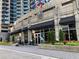 Attractive building exterior with black awnings and landscaped planters at the entrance at 400 W Peachtree Nw St # 3611, Atlanta, GA 30308