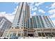Modern high-rise condo building with balconies and street-level shops, parking garage and beautiful landscaping at 400 W Peachtree Nw St # 3611, Atlanta, GA 30308
