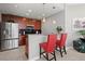 Open kitchen with bar seating, stainless steel refrigerator and dark backsplash at 400 W Peachtree Nw St # 3611, Atlanta, GA 30308
