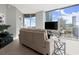 Cozy living room with floor-to-ceiling windows, city views, and contemporary furnishings create an inviting space at 400 W Peachtree Nw St # 3611, Atlanta, GA 30308