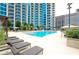 Community pool area with sundeck loungers, umbrellas, and lush landscaping at 400 W Peachtree Nw St # 3611, Atlanta, GA 30308