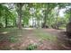View of the wooded backyard showing mature trees and landscaping possibilities at 5666 Goldfield Dr, Acworth, GA 30102
