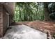 Concrete patio with access to the house surrounded by lush landscaping at 5666 Goldfield Dr, Acworth, GA 30102
