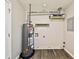 An unfinished basement with a water heater, wood-look flooring, and a window at 5666 Goldfield Dr, Acworth, GA 30102