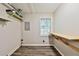 An unfinished basement area with floating shelves and a window for natural light at 5666 Goldfield Dr, Acworth, GA 30102