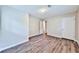 Bedroom with wood-look flooring, neutral walls, and two doors, providing a versatile space at 5666 Goldfield Dr, Acworth, GA 30102