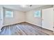 Bedroom with neutral walls, two windows, and wood-look flooring at 5666 Goldfield Dr, Acworth, GA 30102