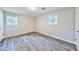 Bedroom with neutral walls, two windows, and wood-look flooring at 5666 Goldfield Dr, Acworth, GA 30102